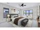 Serene bedroom with panelled wall, a plush bed, ample natural light, and elegant furnishings at 26655 S 169Th Pl, Queen Creek, AZ 85142