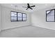 Bright, spacious bedroom with a ceiling fan and large windows offering ample natural light at 26655 S 169Th Pl, Queen Creek, AZ 85142