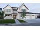 Beautiful two-story home featuring a manicured lawn, gray brick, black window trim and a three car garage at 26655 S 169Th Pl, Queen Creek, AZ 85142