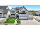 Stunning two-story home with a three-car garage, lush green lawn, and modern farmhouse accents at 26655 S 169Th Pl, Queen Creek, AZ 85142