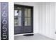 Elegant black double front doors framed by modern house numbers and stylish white siding at 26655 S 169Th Pl, Queen Creek, AZ 85142