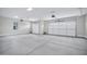 Spacious three car garage with smooth concrete flooring and three garage door entries at 26655 S 169Th Pl, Queen Creek, AZ 85142