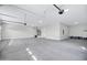 Spacious three-car garage with smooth concrete floors, water heater and an entrance doorway at 26655 S 169Th Pl, Queen Creek, AZ 85142