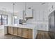 Bright kitchen featuring a large island, stainless steel appliances, pendant lighting and white cabinetry at 26655 S 169Th Pl, Queen Creek, AZ 85142