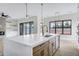 Bright kitchen featuring a large island connecting to a living room with a fireplace and lots of light at 26655 S 169Th Pl, Queen Creek, AZ 85142
