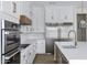 Bright kitchen featuring stainless steel appliances, white cabinetry and modern gold hardware at 26655 S 169Th Pl, Queen Creek, AZ 85142