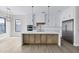 Bright kitchen featuring a large island, stainless steel appliances, pendant lighting and white cabinetry at 26655 S 169Th Pl, Queen Creek, AZ 85142