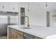 Close up of bright kitchen island with seating, stainless steel appliances and modern gold hardware at 26655 S 169Th Pl, Queen Creek, AZ 85142