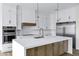 Bright kitchen featuring a large island with stainless steel appliances and modern white cabinetry at 26655 S 169Th Pl, Queen Creek, AZ 85142