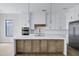 Bright kitchen featuring a large island, stainless steel appliances, pendant lighting and white cabinetry at 26655 S 169Th Pl, Queen Creek, AZ 85142