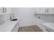 Well-lit laundry room featuring a quartz counter, white cabinets, and bronze hardware at 26655 S 169Th Pl, Queen Creek, AZ 85142