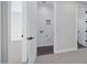 The doorway to the laundry room with gray tile flooring, white walls, and electrical/plumbing hookups at 26655 S 169Th Pl, Queen Creek, AZ 85142