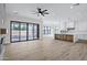 Open-concept living room featuring a large sliding glass doors, a fireplace, and a ceiling fan at 26655 S 169Th Pl, Queen Creek, AZ 85142