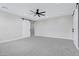 Bright main bedroom offers great square footage, carpet flooring, ceiling fan, and a barn door entry at 26655 S 169Th Pl, Queen Creek, AZ 85142