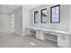 Office nook with a built-in desk area with drawers for extra storage and three windows for natural lighting at 26655 S 169Th Pl, Queen Creek, AZ 85142