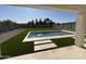 A luxurious backyard oasis featuring a sparkling pool with water features, artificial grass, and ample patio space at 26655 S 169Th Pl, Queen Creek, AZ 85142