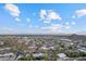 Expansive aerial view of a neighborhood featuring mountain views and a bright blue sky with scattered clouds at 27 W Cochise Dr, Phoenix, AZ 85021