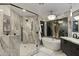 Modern bathroom with marble tile, glass shower, and freestanding tub, creating a spa-like retreat at 27 W Cochise Dr, Phoenix, AZ 85021