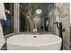 Close-up of a luxurious soaking tub with views of outdoor landscaping, creating a tranquil and private oasis at 27 W Cochise Dr, Phoenix, AZ 85021