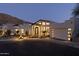 Stunning exterior of the home with a well-manicured yard and accent lighting at dusk at 27 W Cochise Dr, Phoenix, AZ 85021