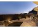 Patio at dusk featuring hot tub, and barstool seating with decorative fence at 27 W Cochise Dr, Phoenix, AZ 85021
