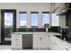 Modern kitchen features sleek white cabinets, black accents, and stainless steel appliances at 27 W Cochise Dr, Phoenix, AZ 85021
