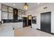 Modern kitchen features sleek white cabinets, black accents, and stainless steel appliances at 27 W Cochise Dr, Phoenix, AZ 85021