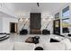 Spacious living room features a modern fireplace, white marble accent wall and sleek flooring at 27 W Cochise Dr, Phoenix, AZ 85021