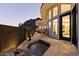 Tile patio at dusk, with hot tub, bar stools, and views of the mountains at 27 W Cochise Dr, Phoenix, AZ 85021