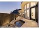 Tile patio featuring hot tub, barstool seating, and architectural exterior at 27 W Cochise Dr, Phoenix, AZ 85021