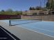 Community tennis court with brick wall and mature landscaping at 27 W Cochise Dr, Phoenix, AZ 85021
