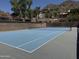 Community tennis court surrounded by brick wall and landscaping at 27 W Cochise Dr, Phoenix, AZ 85021