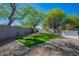 The backyard features a pristine artificial turf, built-in bar, and gravel landscaping for a tranquil escape at 2991 E Folley Pl, Chandler, AZ 85225