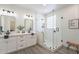 Modern bathroom featuring double sinks, stylish mirrors, and a glass-enclosed shower with modern tile at 2991 E Folley Pl, Chandler, AZ 85225