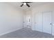 Bedroom featuring closet with sliding doors, gray carpet, and doorway leading to bathroom at 2991 E Folley Pl, Chandler, AZ 85225