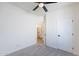 Bedroom with gray carpet, a ceiling fan, and bathroom ensuite with modern fixtures at 2991 E Folley Pl, Chandler, AZ 85225