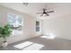 Bright bedroom with a ceiling fan, neutral-toned carpet, and great light from the outside at 2991 E Folley Pl, Chandler, AZ 85225