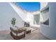 Private courtyard featuring an outdoor fireplace, seating area, and decorative plants at 2991 E Folley Pl, Chandler, AZ 85225