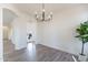 Bright dining room with wood-look flooring and modern chandelier at 2991 E Folley Pl, Chandler, AZ 85225
