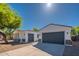 Home exterior featuring attached garages, stucco walls, and desert landscaping at 2991 E Folley Pl, Chandler, AZ 85225