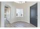 Bright foyer featuring wood-look flooring, white walls, and a decorative arched window at 2991 E Folley Pl, Chandler, AZ 85225