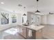 Kitchen island with sink, quartz countertops, and bar seating adjacent to informal dining area at 2991 E Folley Pl, Chandler, AZ 85225