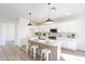Modern kitchen featuring white cabinets, pendant lighting, quartz countertops, and an island with seating at 2991 E Folley Pl, Chandler, AZ 85225