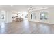 Open-concept living area with kitchen, dining area, and living room with white walls and light wood floors at 2991 E Folley Pl, Chandler, AZ 85225