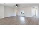 Open concept living room with white walls, wood floors and view into an arched hallway at 2991 E Folley Pl, Chandler, AZ 85225