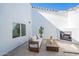 Inviting outdoor patio with a cozy fireplace, stylish seating, and modern design elements at 2991 E Folley Pl, Chandler, AZ 85225