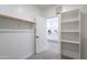 Bright walk-in closet features built-in shelving and open door to a bathroom with modern fixtures at 2991 E Folley Pl, Chandler, AZ 85225
