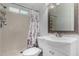 Clean bathroom with a shower, a patterned curtain, a toilet, and a bright vanity at 3021 E Larkspur Dr, Phoenix, AZ 85032