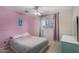 Comfortable bedroom with pink walls, tiled floors, and a ceiling fan at 3021 E Larkspur Dr, Phoenix, AZ 85032