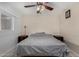 Bright bedroom featuring tiled floors, a ceiling fan, and natural lighting at 3021 E Larkspur Dr, Phoenix, AZ 85032